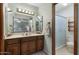 En-suite bathroom with a vanity, decorative mirrors, and access to a glass-enclosed shower at 2616 E Des Moines St, Mesa, AZ 85213