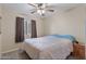 Comfortable bedroom featuring neutral walls, ceiling fan, and ample natural light from the window at 2616 E Des Moines St, Mesa, AZ 85213