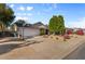 Wide driveway leads to a well-maintained home with green trees and landscape and exterior basketball hoop at 2616 E Des Moines St, Mesa, AZ 85213
