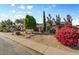 Beautiful single-story home with a nicely landscaped front yard, mature trees, and vibrant flowering bushes at 2616 E Des Moines St, Mesa, AZ 85213