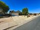 Well-kept single-story home with a large driveway and manicured landscaping at 2616 E Des Moines St, Mesa, AZ 85213
