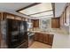 Bright kitchen with wood cabinets, stainless steel appliances and laminate wood floors at 2616 E Des Moines St, Mesa, AZ 85213