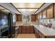 Bright kitchen with wood cabinets, stainless steel appliances and a view of the backyard at 2616 E Des Moines St, Mesa, AZ 85213