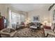 Bright and airy living room with large windows, comfortable seating, and a classic area rug at 2616 E Des Moines St, Mesa, AZ 85213