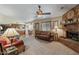 Inviting living room with a brick fireplace, plush sofa, and an open layout leading to the kitchen at 2616 E Des Moines St, Mesa, AZ 85213
