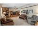 Spacious living room featuring a brick fireplace, built-in media center, and comfortable seating arrangement at 2616 E Des Moines St, Mesa, AZ 85213