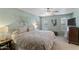 Spacious bedroom featuring neutral decor, a ceiling fan, and a large comfortable bed at 2616 E Des Moines St, Mesa, AZ 85213