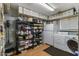 Well stocked pantry with shelving, extra refrigerator, and a washer and dryer at 2616 E Des Moines St, Mesa, AZ 85213