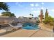 Backyard pool with lounge chairs and mature landscaping creating a private oasis at 2616 E Des Moines St, Mesa, AZ 85213