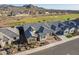 Community houses with golf course, lush landscaping, and desert mountains views at 26689 W Ponderosa Ln, Buckeye, AZ 85396