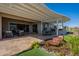 Inviting covered patio with a water feature, comfortable seating, and an outdoor dining area perfect for entertaining at 26689 W Ponderosa Ln, Buckeye, AZ 85396