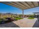 Backyard featuring water feature, lush landscaping, and mountain views at 26689 W Ponderosa Ln, Buckeye, AZ 85396