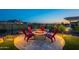 Inviting backyard featuring a cozy fire pit area with mountain views and lush landscaping for relaxing evenings at 26689 W Ponderosa Ln, Buckeye, AZ 85396