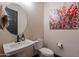 Charming powder room with a pedestal sink and decorative artwork at 26689 W Ponderosa Ln, Buckeye, AZ 85396