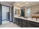 Modern bathroom features dual sinks, elegant cabinetry, and a large mirror at 26689 W Ponderosa Ln, Buckeye, AZ 85396