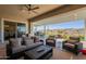 Enjoy the expansive covered patio with ceiling fan, outdoor dining area and lounge seating at 26689 W Ponderosa Ln, Buckeye, AZ 85396
