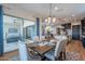 Dining area features a rustic wooden table, elegant decor, and sliding glass doors to a patio at 26689 W Ponderosa Ln, Buckeye, AZ 85396