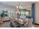Elegant dining room with stylish decor, chandelier lighting, and sliding doors to the outdoor patio at 26689 W Ponderosa Ln, Buckeye, AZ 85396