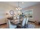 Beautiful dining room with an ornate chandelier, wood table, and neutral decor at 26689 W Ponderosa Ln, Buckeye, AZ 85396