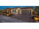 Charming single-Gathering home featuring a three car garage, stone accents, and desert landscaping for curb appeal at 26689 W Ponderosa Ln, Buckeye, AZ 85396
