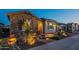 Well-maintained home featuring a stone facade, manicured desert landscaping, and welcoming front entrance at 26689 W Ponderosa Ln, Buckeye, AZ 85396