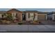 Inviting home exterior with stone accents, desert landscaping, paved walkway, and a two-car garage at 26689 W Ponderosa Ln, Buckeye, AZ 85396