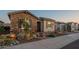 Beautiful home with stone accents, desert landscaping, walkway lighting, and a two-car garage under clear skies at 26689 W Ponderosa Ln, Buckeye, AZ 85396