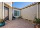 Inviting front patio featuring decorative pots, paved flooring, and pleasant curb appeal at 26689 W Ponderosa Ln, Buckeye, AZ 85396