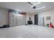 Spacious garage with ample storage cabinets and epoxy floors at 26689 W Ponderosa Ln, Buckeye, AZ 85396
