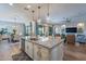 Gourmet kitchen with a large island, granite countertops, pendant lighting, and an open-concept layout at 26689 W Ponderosa Ln, Buckeye, AZ 85396