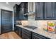 Modern kitchen with dark cabinetry, granite countertops, and stainless steel appliances at 26689 W Ponderosa Ln, Buckeye, AZ 85396