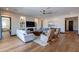 Bright living room with hardwood floors, comfortable seating, built-in shelving, and a fireplace at 26689 W Ponderosa Ln, Buckeye, AZ 85396