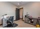 Bright office space featuring a desk, chair, and storage cabinet with a heat press at 26689 W Ponderosa Ln, Buckeye, AZ 85396