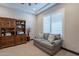 Office with shutters, bookcase and gray loveseat with striped throw pillows at 26689 W Ponderosa Ln, Buckeye, AZ 85396