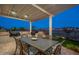 Enjoy outdoor dining on this covered patio with a built-in grill and views of the serene backyard at 26689 W Ponderosa Ln, Buckeye, AZ 85396