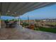 Entertain on this covered patio with outdoor kitchen, dining area, and peaceful view of the backyard at 26689 W Ponderosa Ln, Buckeye, AZ 85396