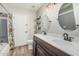Inviting bathroom featuring a double vanity, wood-look flooring, and a bathtub with a floral shower curtain at 2726 E Hale St, Mesa, AZ 85213