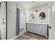Beautiful bathroom featuring double sinks, wood-look flooring, and a glass-enclosed shower with stylish tile at 2726 E Hale St, Mesa, AZ 85213