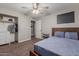 Comfortable bedroom with wood bedframe, carpeted floors, ceiling fan, and a spacious closet at 2726 E Hale St, Mesa, AZ 85213