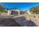 Wide driveway and large two-car garage in front of single-story home with brick accents and neutral stucco at 2726 E Hale St, Mesa, AZ 85213