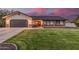 Charming single-story home featuring a well-manicured lawn, brick accents, and a two-car garage at 2726 E Hale St, Mesa, AZ 85213