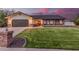 Charming single-story home featuring a well-manicured lawn, brick accents, and a two-car garage at 2726 E Hale St, Mesa, AZ 85213