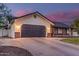 Home exterior showcasing an attached garage with a paved driveway and manicured landscaping at 2726 E Hale St, Mesa, AZ 85213