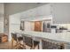 Modern kitchen with a long breakfast bar offering seating for three and white cabinetry for storage at 2726 E Hale St, Mesa, AZ 85213