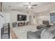 Bright living room features vaulted ceiling, fireplace, large TV, and comfortable seating for relaxing and entertaining at 2726 E Hale St, Mesa, AZ 85213