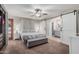 Relaxing main bedroom boasts a ceiling fan, ensuite bathroom with sliding barn doors, and natural light at 2726 E Hale St, Mesa, AZ 85213
