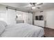 Main bedroom features an ensuite bathroom with sliding barn doors and a ceiling fan for added comfort at 2726 E Hale St, Mesa, AZ 85213