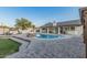 Beautiful in-ground pool with diving board, fireplace, outdoor kitchen and stone pavers, perfect for entertaining at 2726 E Hale St, Mesa, AZ 85213
