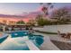 Backyard oasis with a sparkling pool, built-in barbecue, and picturesque sunset views at 2726 E Hale St, Mesa, AZ 85213