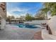 Gorgeous in-ground pool with diving board, waterfall feature, and outdoor kitchen area, perfect for summer fun at 2726 E Hale St, Mesa, AZ 85213